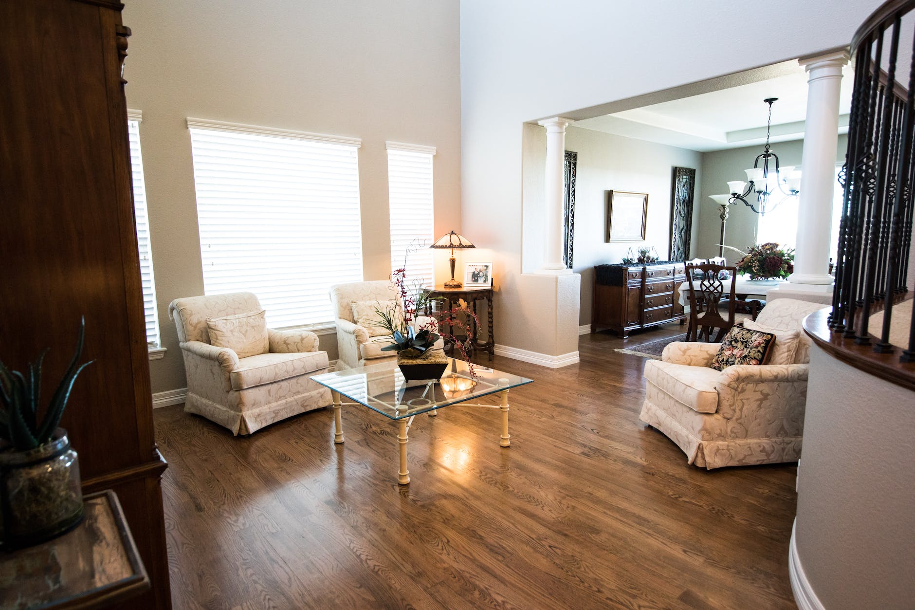 square clear glass top center table near gray padded armchair