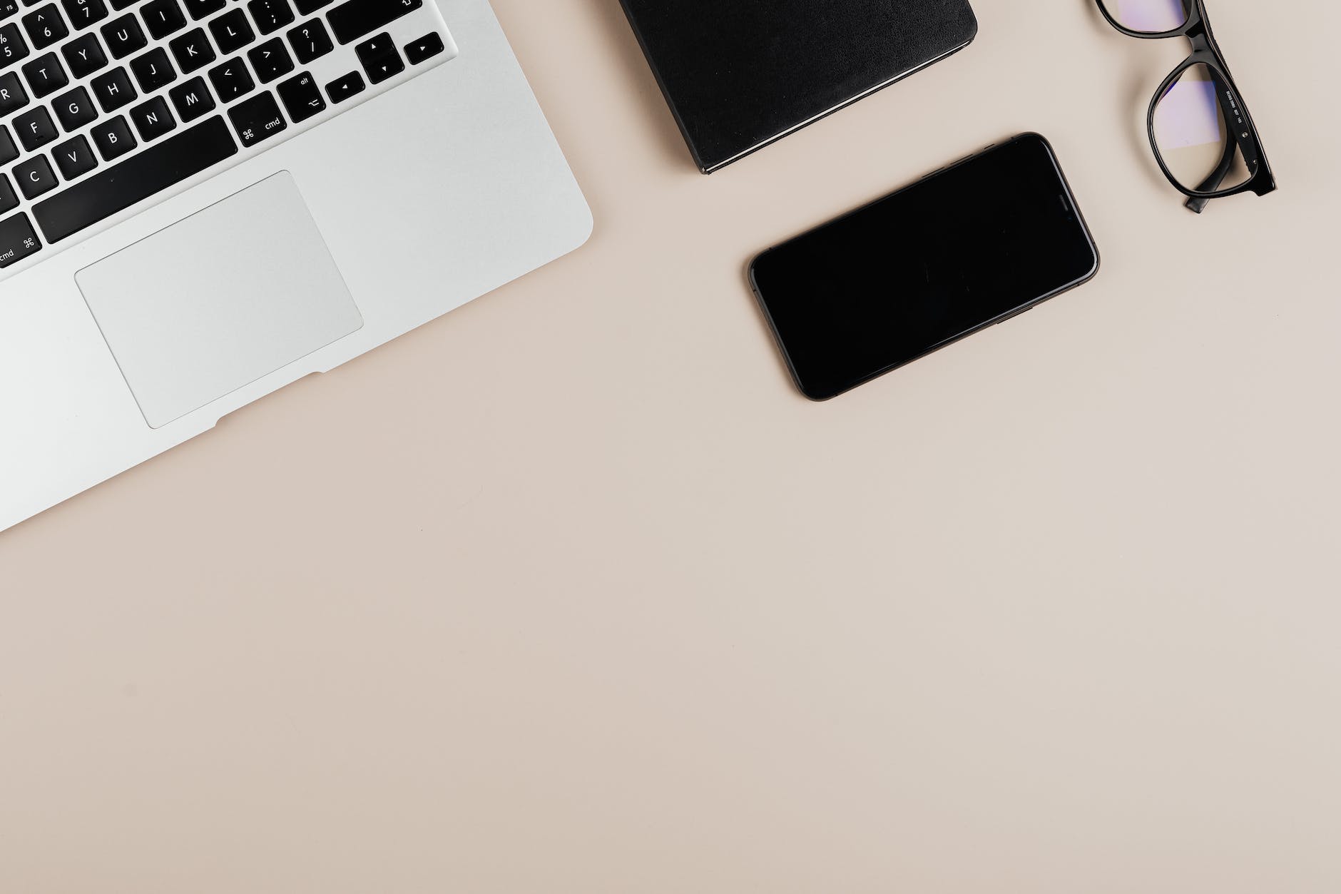 macbook pro beside black ipad on white table