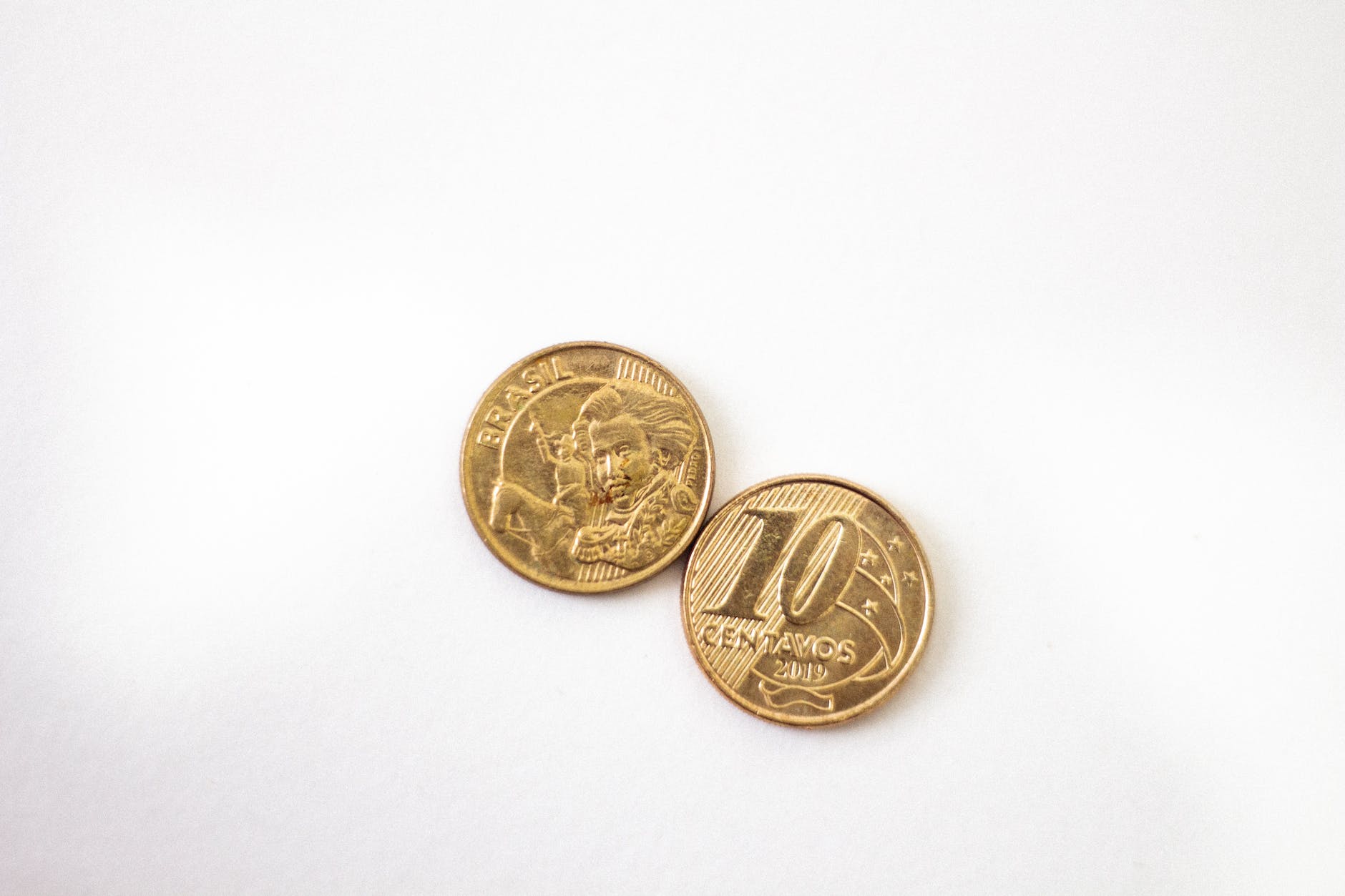 gold round coins on white surface